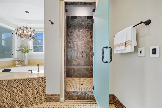 a bathroom with a granite countertop sink toilet a mirror and shower