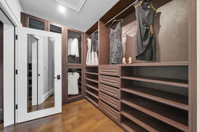 a bathroom with a granite countertop sink a toilet a shower and a mirror