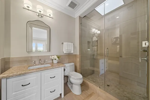 a living room with furniture kitchen and a potted plant