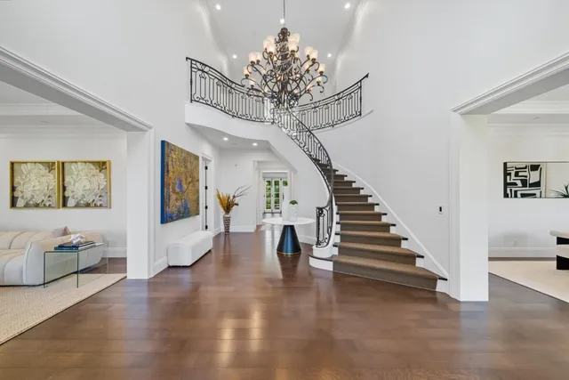 a living room with furniture and a chandelier
