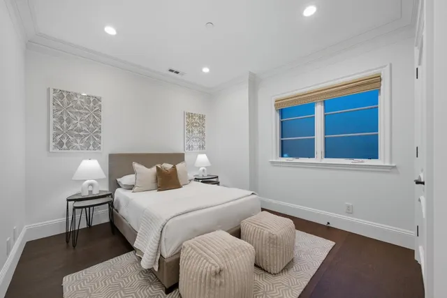 a view of a backyard with plants and a fountain