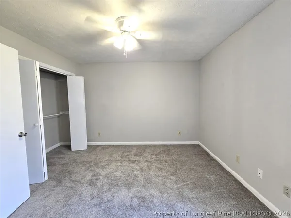 an empty room with a empty space and a ceiling fan