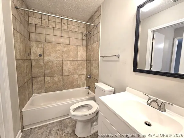 a bathroom with a sink a toilet and a bathtub