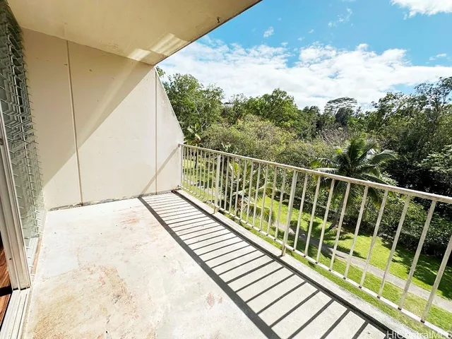 a view of balcony with wooden floor and fence