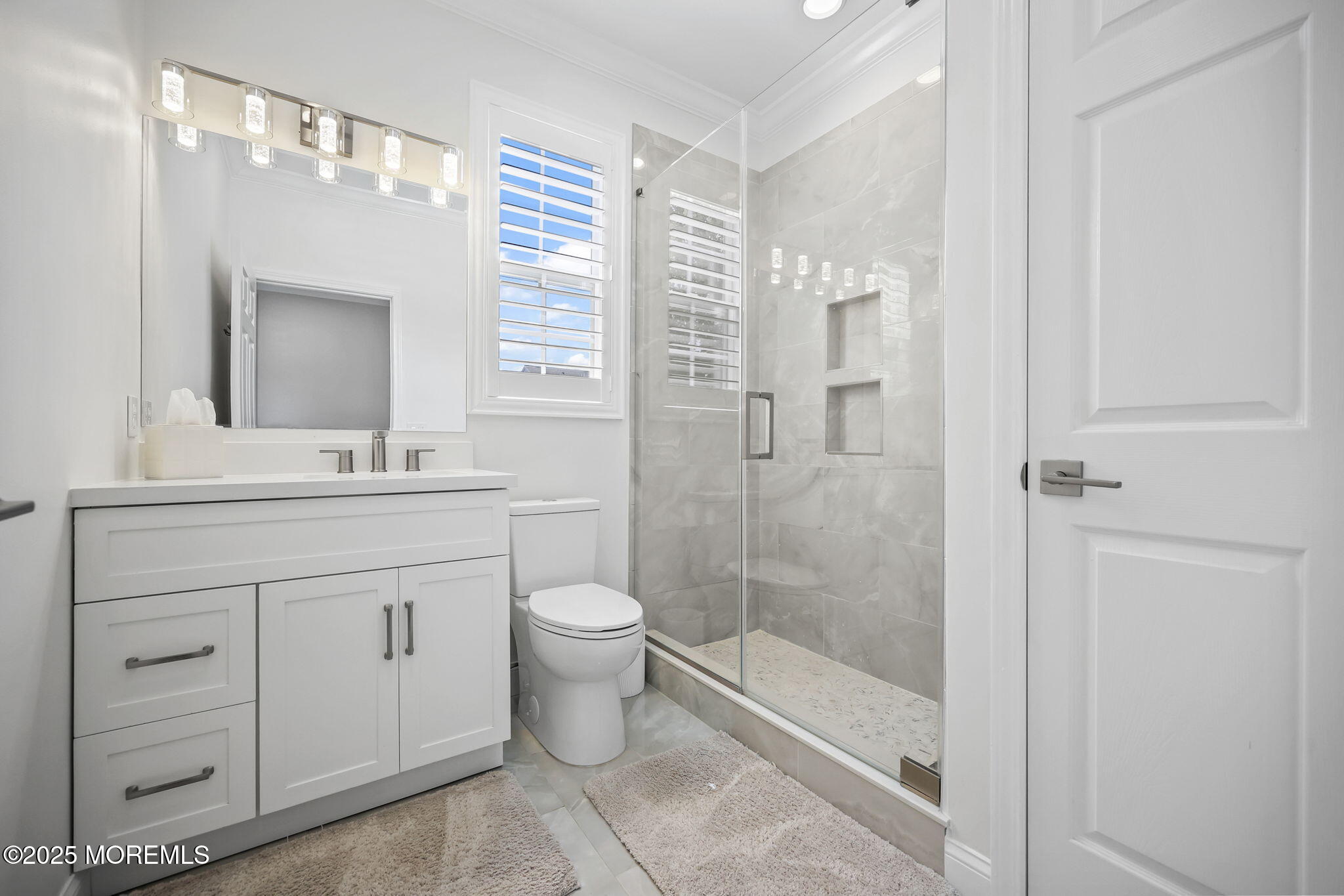 21 Silver Maple Lane Howell, NJ 07731 - Photo 6 of 22 a bathroom with a toilet a sink and a large mirror
