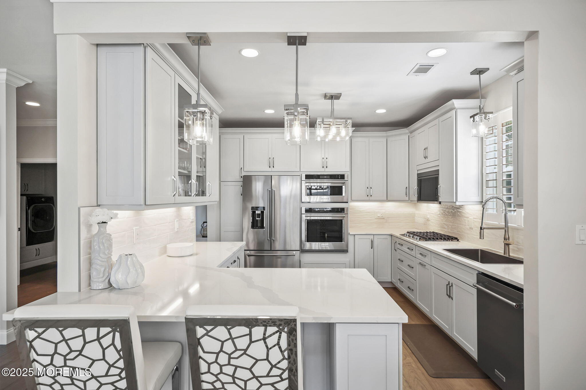 21 Silver Maple Lane Howell, NJ 07731 - Photo 10 of 22 a kitchen with stainless steel appliances kitchen island granite countertop a table chairs sink and cabinets
