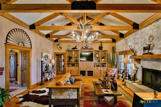 a living room with fireplace furniture and a fireplace