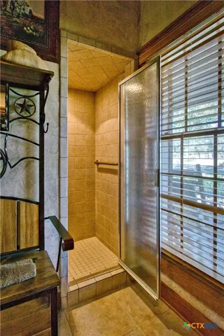 a bathroom with a bathtub and a shower