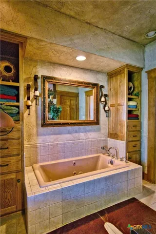 a bathroom with a sink a mirror and a bathtub