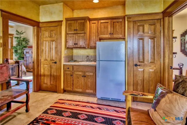 a bedroom with bed and a chandelier
