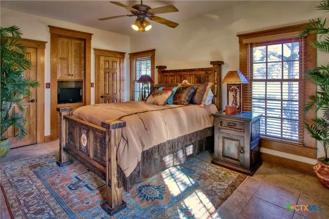 a bedroom with a bed and a glass door shower