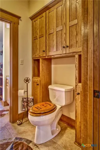 a view of a patio with table and chairs potted plants and large tree