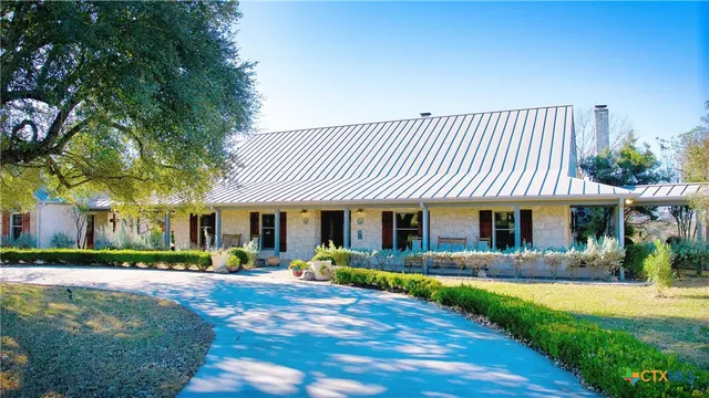 a front view of a house with yard and green space