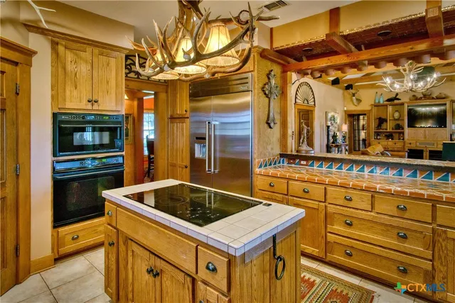 a kitchen with stainless steel appliances granite countertop a sink and cabinets