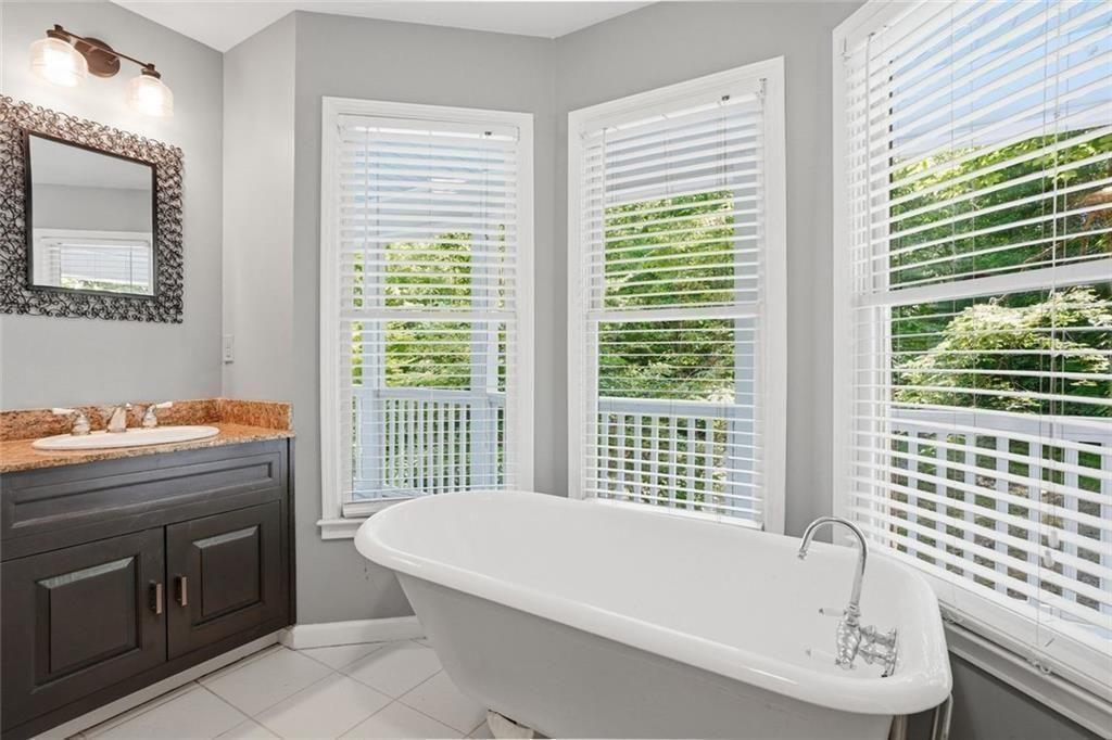 3259 Etchison Road Loganville, GA 30052 - Photo 22 of 50 a bathroom with a bathtub and next to a window