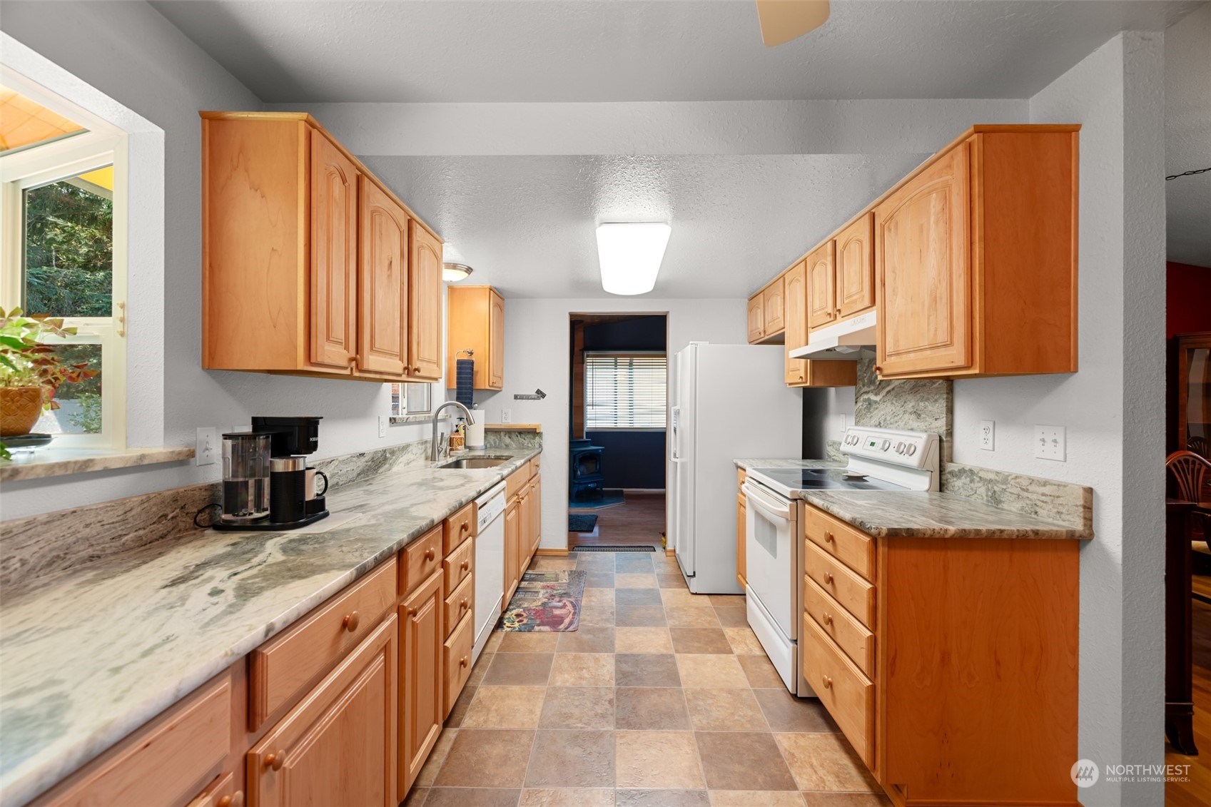 107 Peterson Road Chehalis, WA 98532 - Photo 19 of 35 a kitchen with stainless steel appliances granite countertop a stove a sink dishwasher and a microwave oven with white cabinets