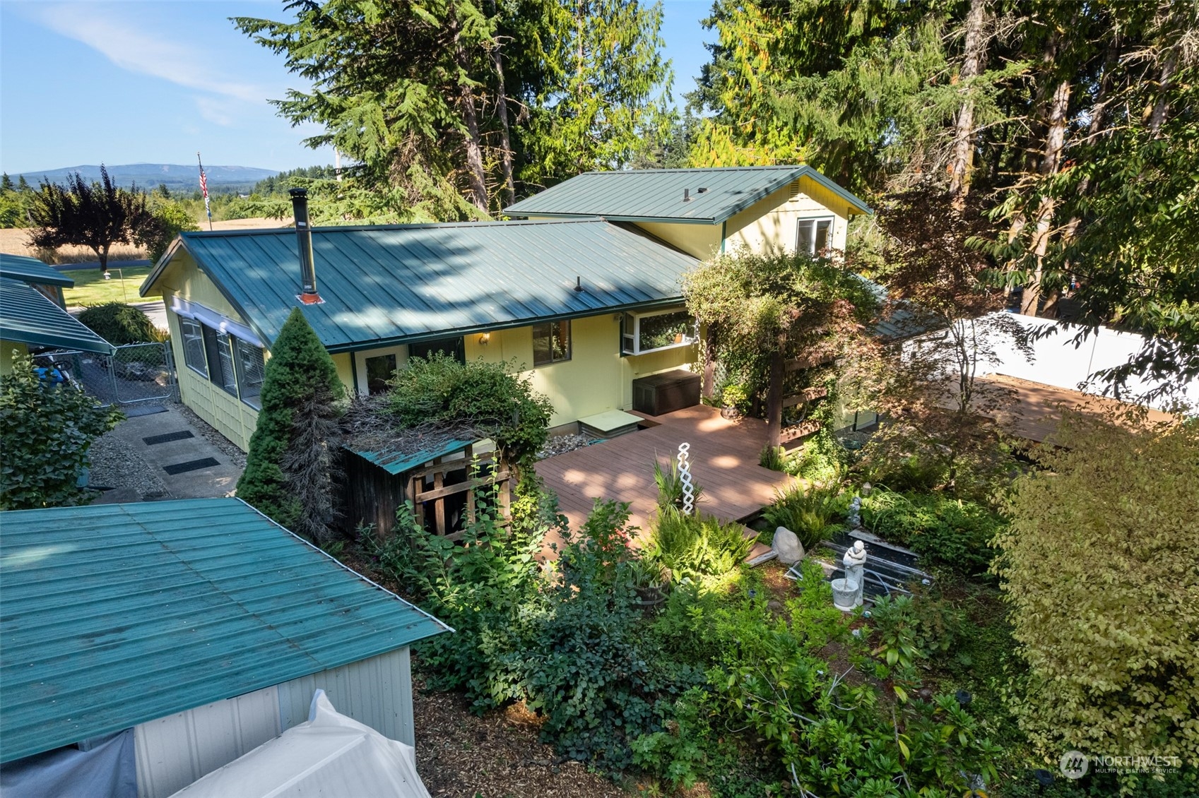 107 Peterson Road Chehalis, WA 98532 - Photo 2 of 35 a backyard of a house with table and chairs under an umbrella