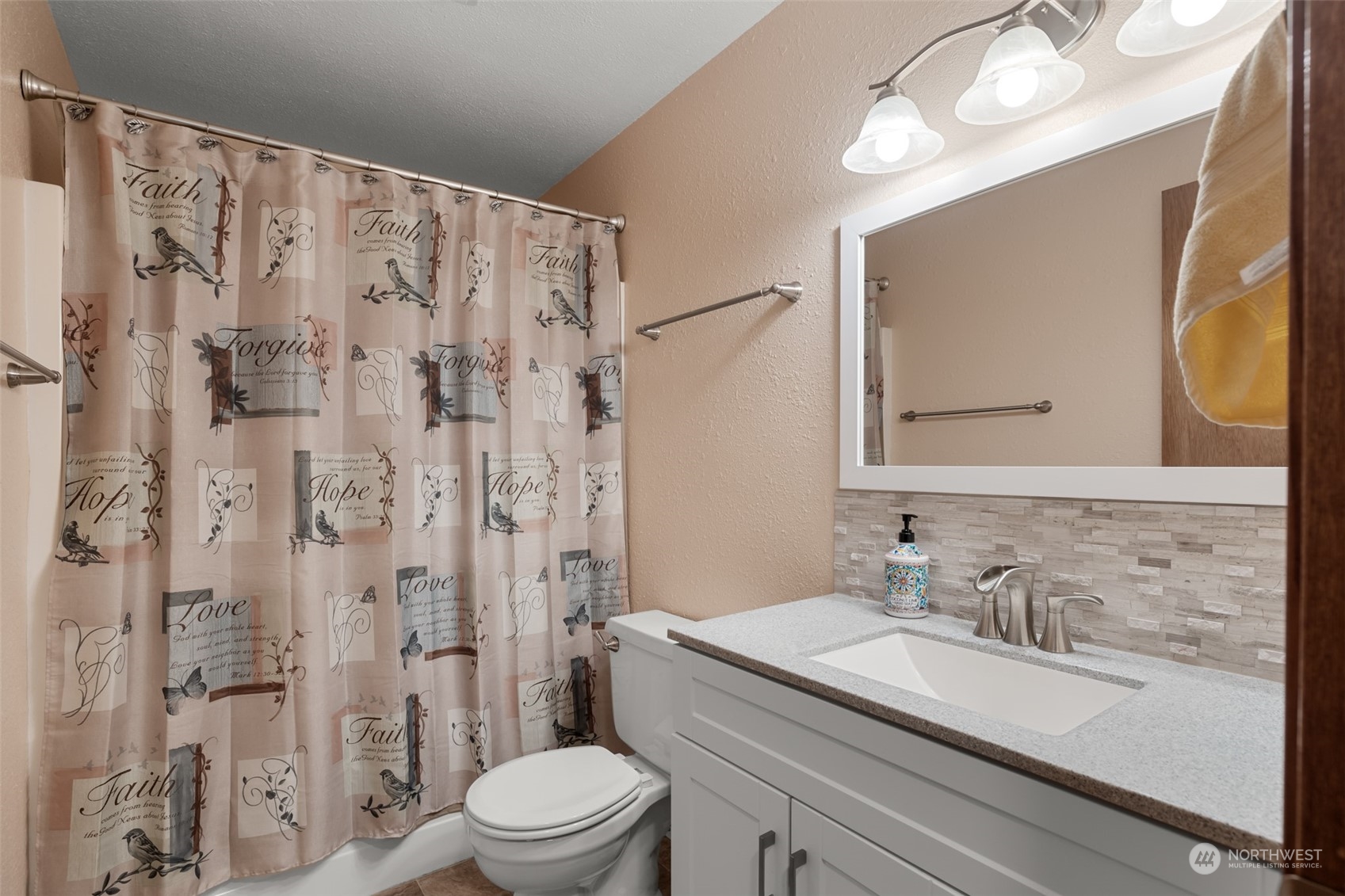 107 Peterson Road Chehalis, WA 98532 - Photo 32 of 35 a bathroom with a granite countertop sink a toilet a mirror a vanity and shower