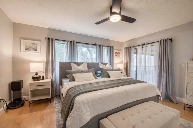 a bedroom with a bed a couch and a chandelier