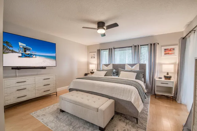 a spacious bedroom with a bed and a dresser