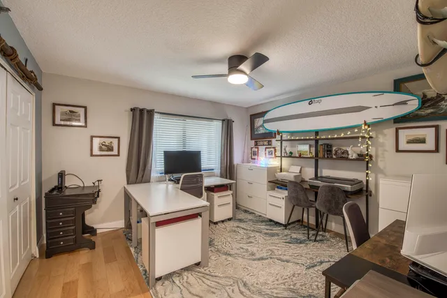 a living room with furniture a flat screen tv and a window