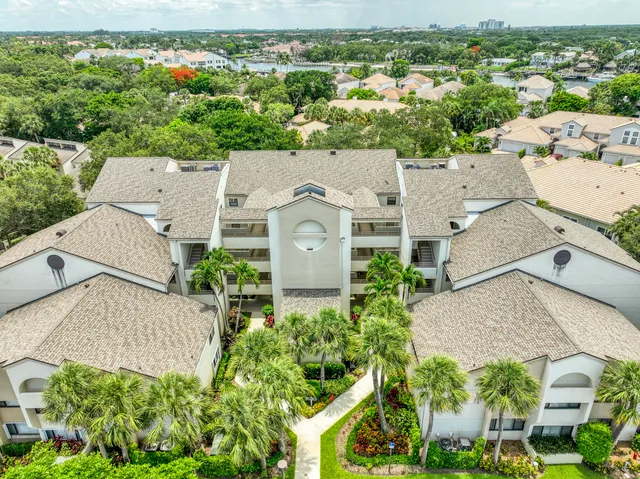 an aerial view of a house with a yard and garden