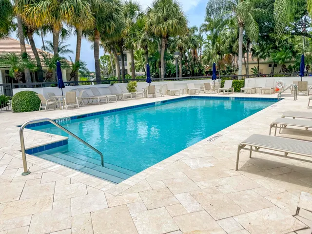 a view of swimming pool with a patio and a yard