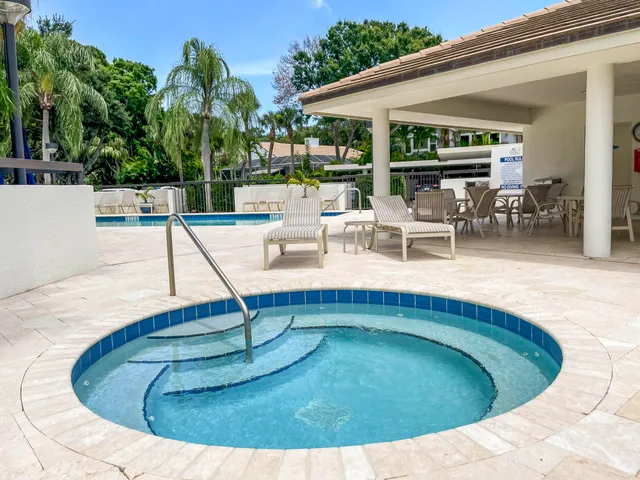 a view of a swimming pool with outdoor seating