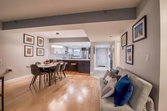 a living room with furniture and a dining table