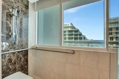 a bedroom with a bed and large flat screen tv