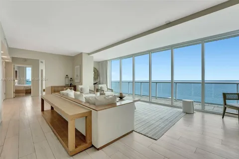 a large white room with a large window and furniture