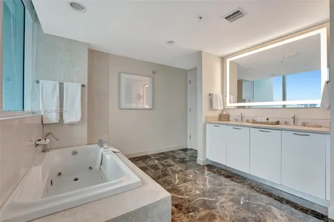a bathroom with a bathtub and a sink