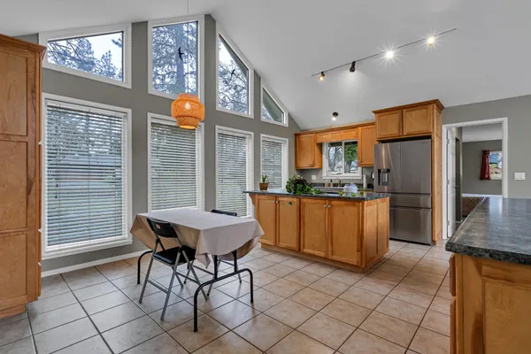 a kitchen with granite countertop a sink and cabinets