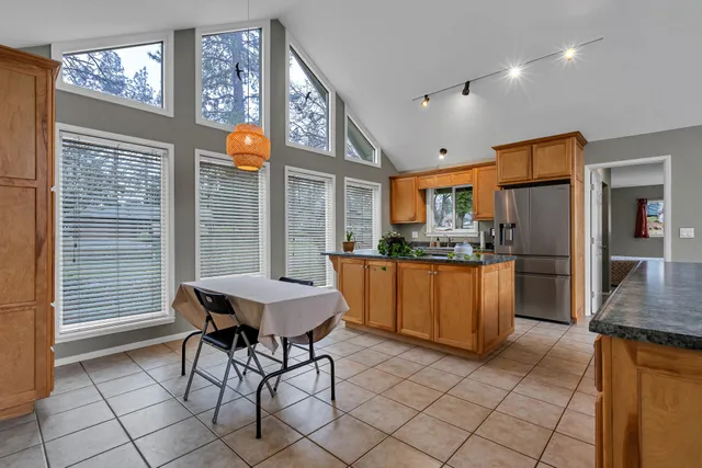 a kitchen with granite countertop a sink and cabinets