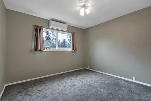 a backyard of a house with barbeque oven table and chairs