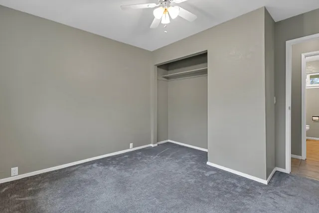 a front view of a house with a garden and trees