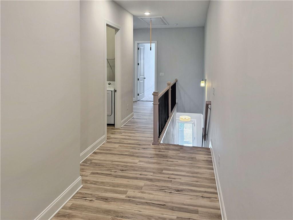 677 Stickley Oak Way Woodstock, GA 30189 - Photo 15 of 30 a view of a hallway with wooden floor and staircase