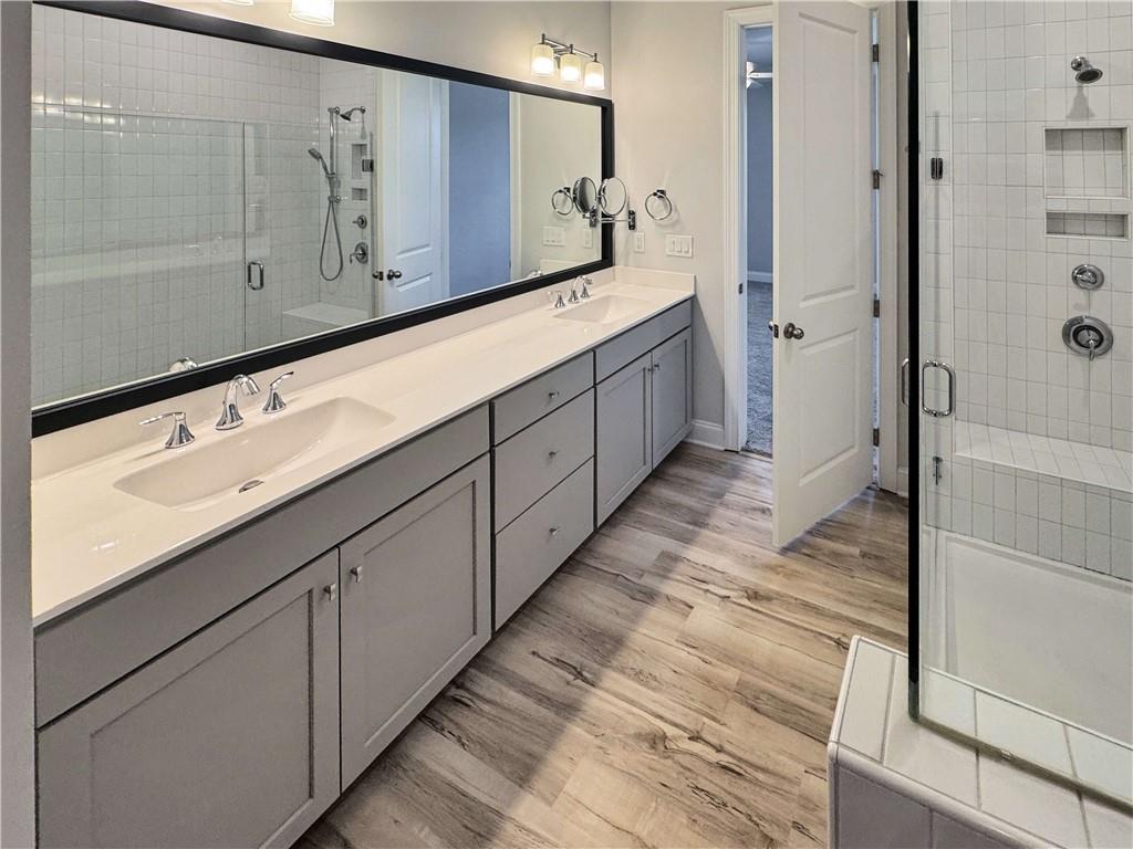 677 Stickley Oak Way Woodstock, GA 30189 - Photo 20 of 30 a bathroom with a double vanity sink and mirror