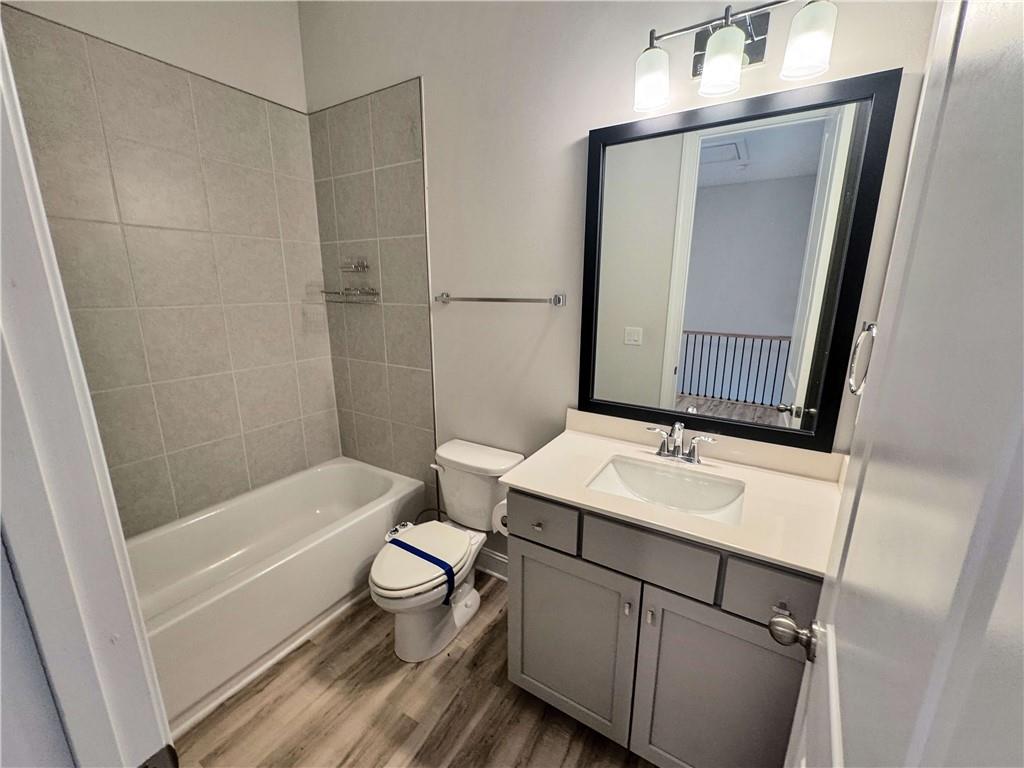 677 Stickley Oak Way Woodstock, GA 30189 - Photo 27 of 30 a bathroom with a sink a toilet a mirror and shower