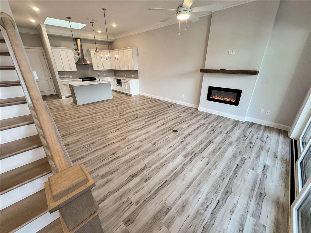 677 Stickley Oak Way Woodstock, GA 30189 - Photo 4 of 30 a open kitchen with kitchen island white cabinets and stainless steel appliances
