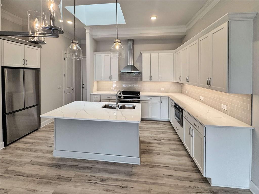 677 Stickley Oak Way Woodstock, GA 30189 - Photo 7 of 30 a kitchen with stainless steel appliances granite countertop a sink stove and refrigerator