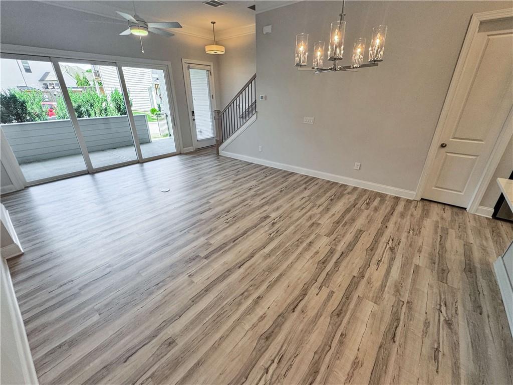 677 Stickley Oak Way Woodstock, GA 30189 - Photo 8 of 30 a view of empty room with wooden floor and fan