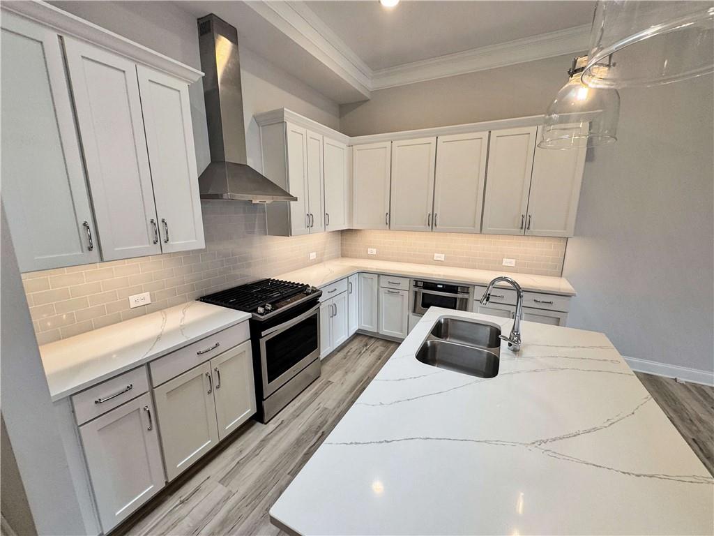 677 Stickley Oak Way Woodstock, GA 30189 - Photo 9 of 30 a kitchen with a sink a stove and cabinets