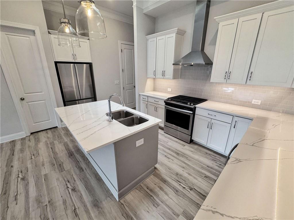 677 Stickley Oak Way Woodstock, GA 30189 - Photo 10 of 30 a kitchen with granite countertop a sink stove and refrigerator