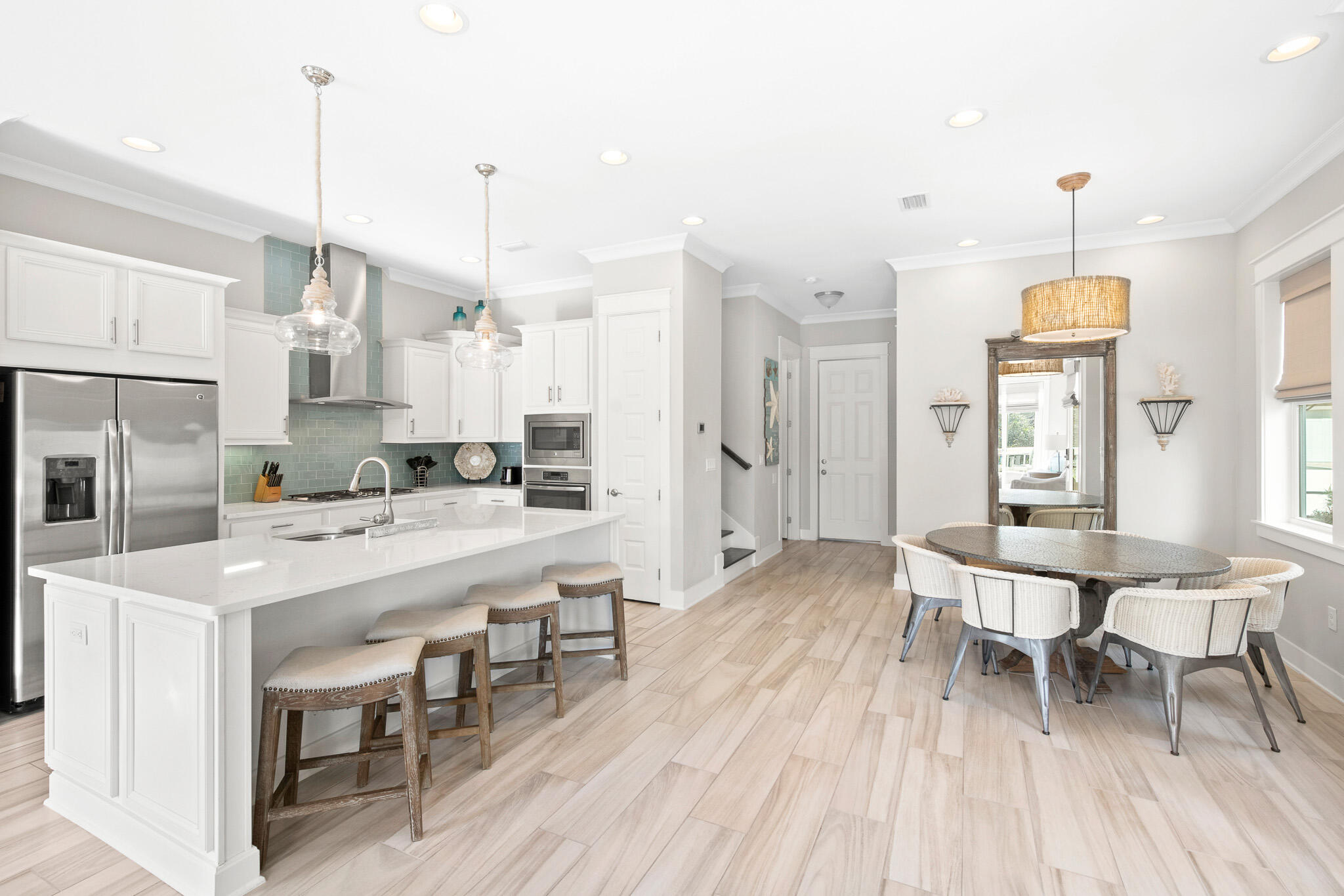 a large kitchen with a table and chairs