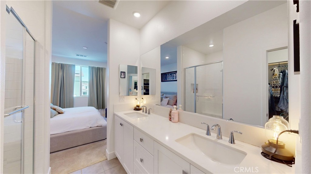 2221 Bluegrass Way Rancho Mission Viejo, CA 92694 - Photo 17 of 35 a bathroom with a double vanity sink and mirror