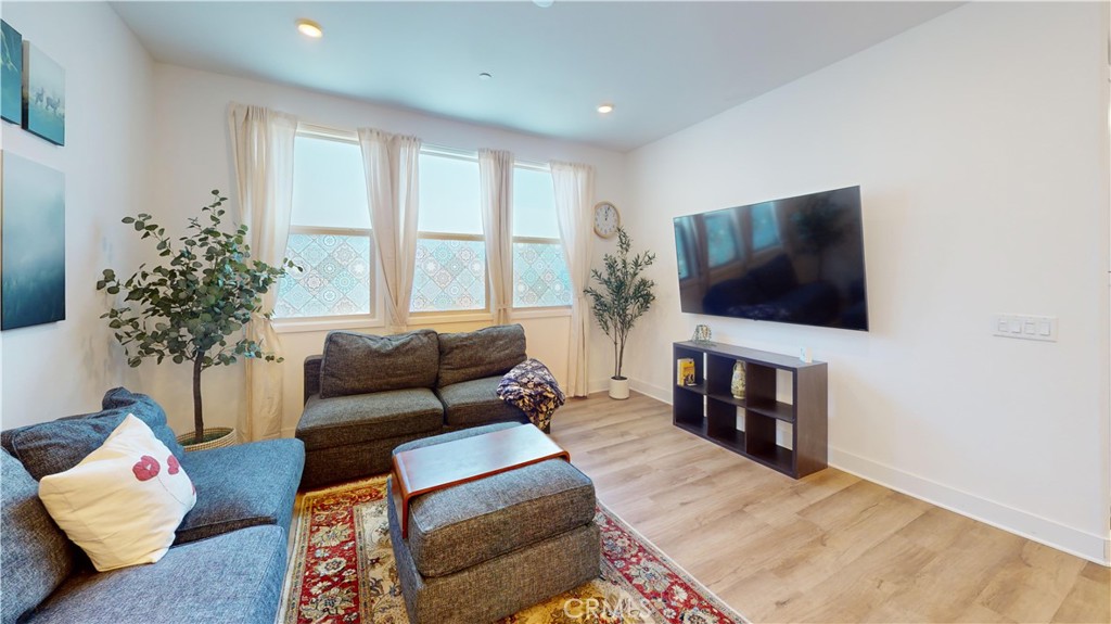 2221 Bluegrass Way Rancho Mission Viejo, CA 92694 - Photo 10 of 35 a living room with furniture and a flat screen tv