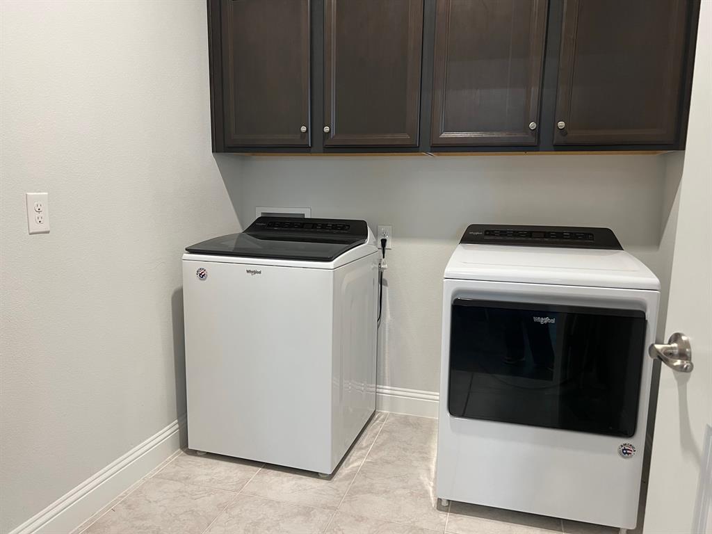 651 Watters Road, Unit 7101 Allen, TX 75013 - Photo 18 of 25 Laundry area featuring full size washer and dryer and cabinet space
