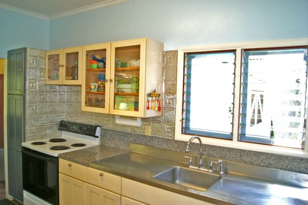 6544 Kipapa Road Kapaa, HI 96746 - Photo 3 of 25 a kitchen with a sink and a stove next to a large window