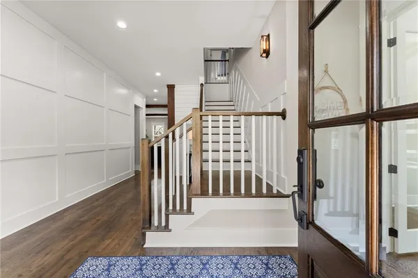 a view of staircase with white walls and a window